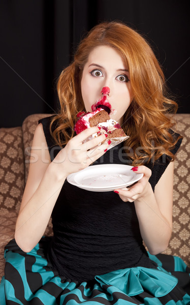 Redhead girl secretly eating cake. Stock photo © Massonforstock