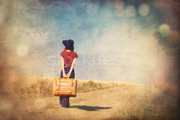 beautiful young woman with suitcase standing in the middle of th Stock photo © Massonforstock