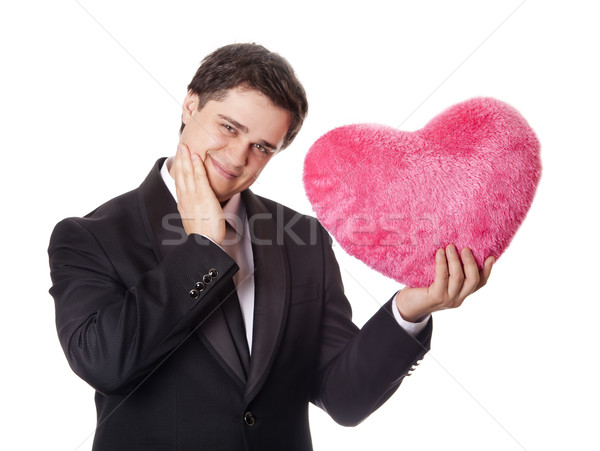 A man holding toy heart in formal black tux with tie isolated on Stock photo © Massonforstock