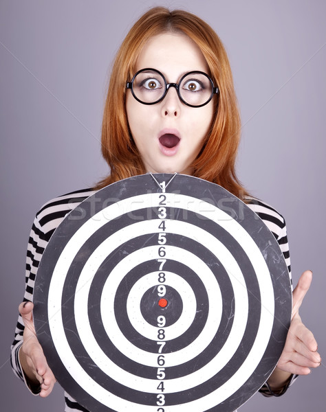 Red-haired girl with dartboard. Stock photo © Massonforstock