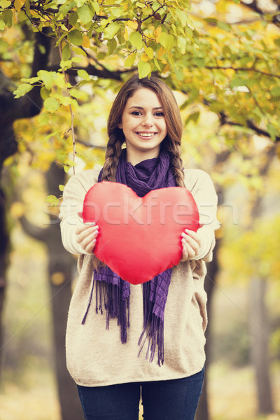 Redhead girl with toy heart at autumn park. Stock photo © Massonforstock