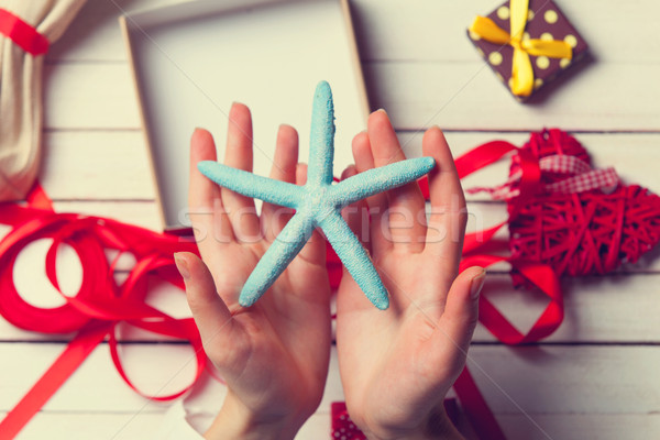 female hands holding a blue star Stock photo © Massonforstock