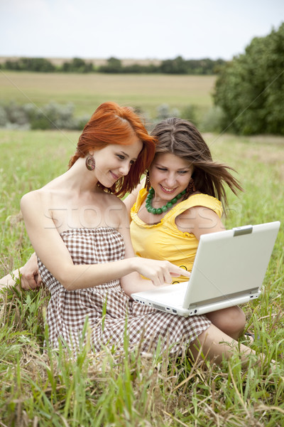 Stock photo: Two beautiful girls with notebook