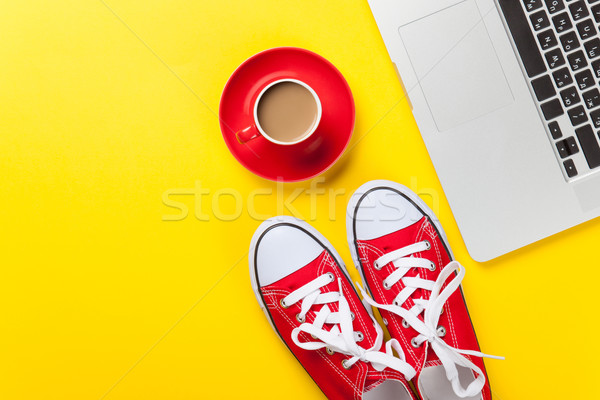 Stock photo: Cup and laptop computer with gumshoes 