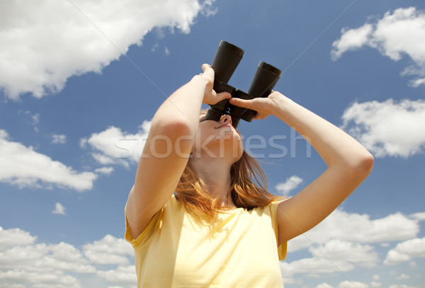 Girl with binocular watching in sky. Stock photo © Massonforstock