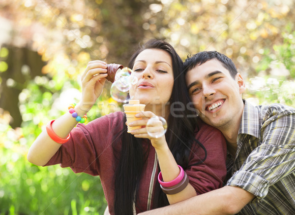 Pareja relajante parque burbuja soplador primavera Foto stock © Massonforstock