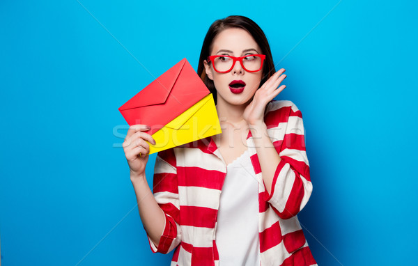 surprised woman with two envelopes Stock photo © Massonforstock