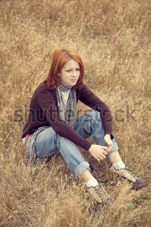 Lonely sad red-haired girl at field Stock photo © Massonforstock