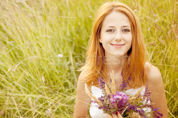 Redhead girl at outdoor with flowers. Stock photo © Massonforstock