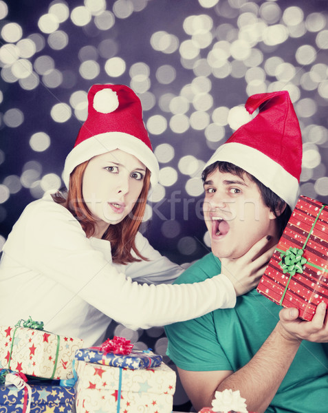 Girl strangling her boyfriend for a christmas gift.  Stock photo © Massonforstock
