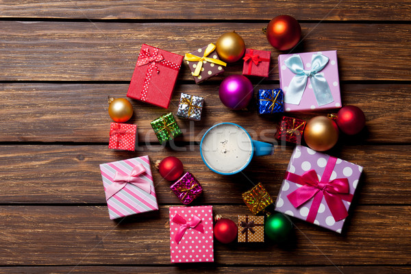 Stock photo: Cup of coffee and Christmas gifts 