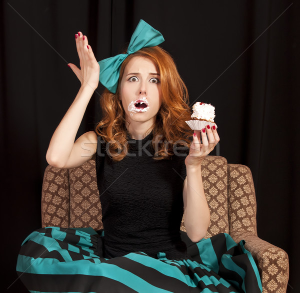 Redhead girl secretly eating cake. Stock photo © Massonforstock