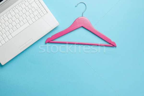 Stock photo: photo of wooden hanger and laptop on the wonderful blue backgrou