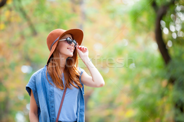 photo of beautiful young woman standing on the wonderful autumn  Stock photo © Massonforstock