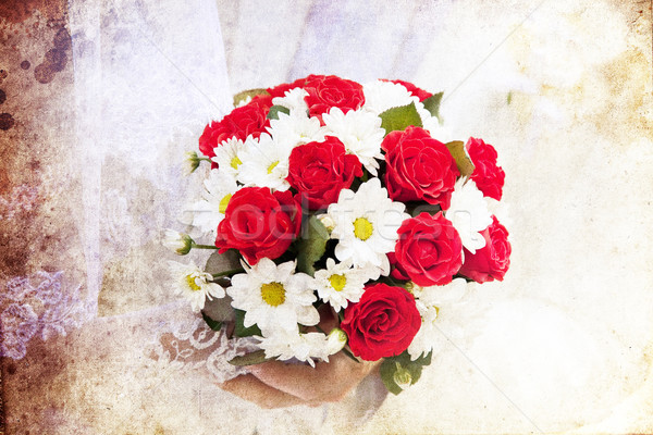 Bridegroom and bride holding beautiful red roses wedding flowers Stock photo © Massonforstock