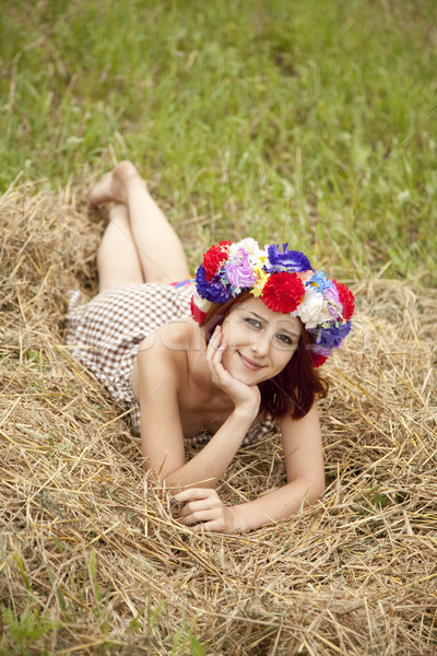 Girl in Slav national wreath lying at field. Stock photo © Massonforstock