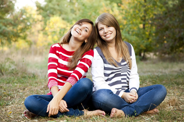 Stock photo: Portrait of redhead and brunette girls at outdoor.