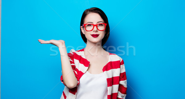 portrait of the beautiful young smiling woman on the blue backgr Stock photo © Massonforstock