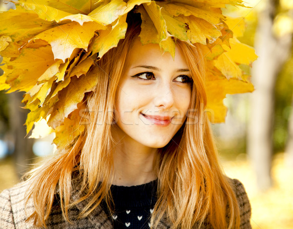 Smiling happy girl in autumn leaves. Stock photo © Massonforstock