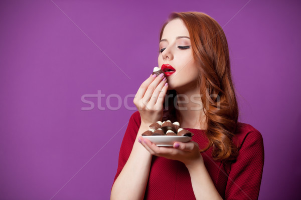 photo of beautiful young woman with plate full of chocolate cand Stock photo © Massonforstock