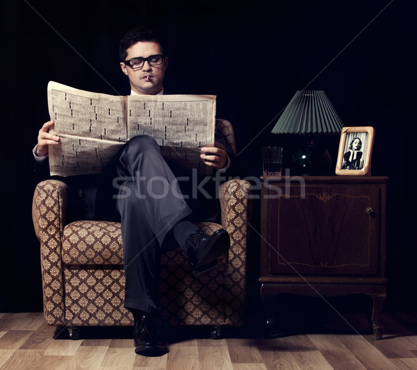 Hombre periódico sesión vintage sillón ojos Foto stock © Massonforstock