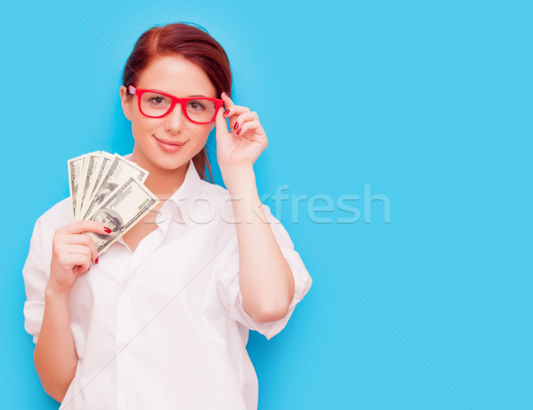 Stock photo: Portrait of redhead woman in red glasses with money 