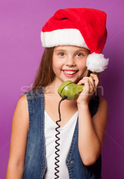 girl in red Santas hat with green handset  Stock photo © Massonforstock