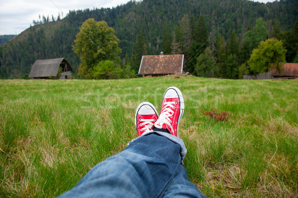 Stock photo: photo of male legs in jeans and red gumshoes on the wonderful vi