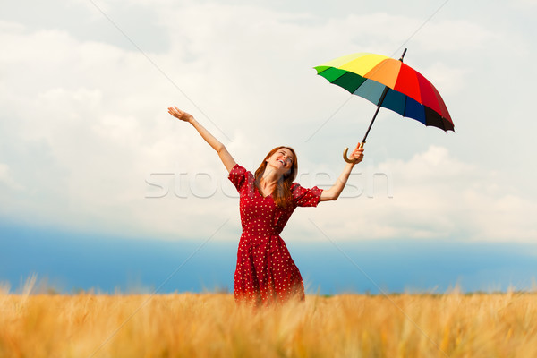 Redhead girl with umbrella at field Stock photo © Massonforstock