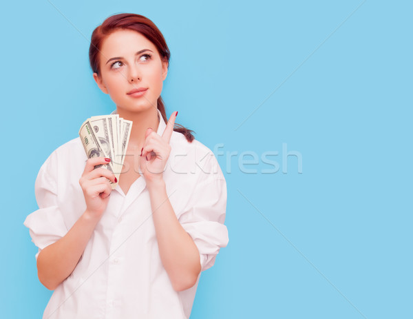 Stock photo: Portrait of redhead woman with money