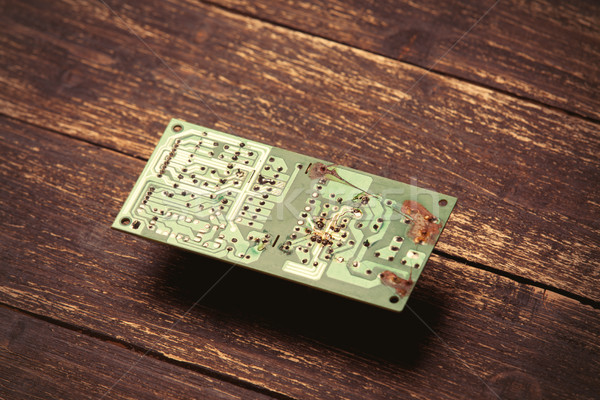 photo of cool small modern microchip on the wooden brown backgro Stock photo © Massonforstock