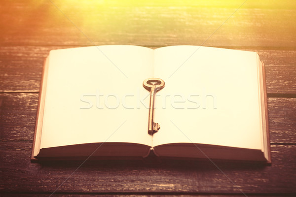 photo of cool empty notebook and key on the wonderful brown wood Stock photo © Massonforstock
