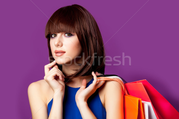 photo of beautiful young woman with colorful shopping bags on th Stock photo © Massonforstock