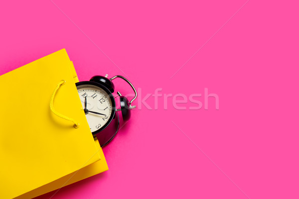 cool black alarm clock in beautiful yellow shopping bag on the w Stock photo © Massonforstock