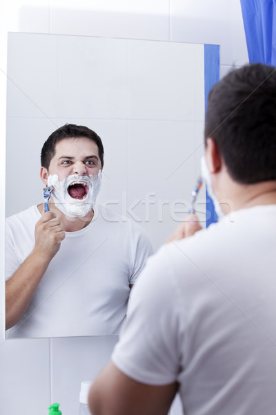 Stock photo: Surprised real men shaving.