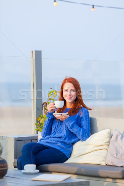 beautiful young woman with cup of coffee sitting in the cafe on  Stock photo © Massonforstock