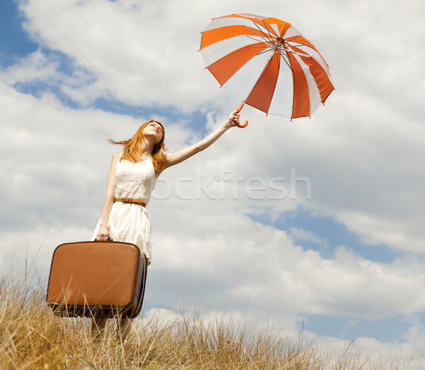 Gyönyörű vörös hajú nő lány esernyő bőrönd szabadtér Stock fotó © Massonforstock