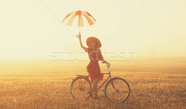 Meisje paraplu fiets platteland zonsopgang tijd Stockfoto © Massonforstock