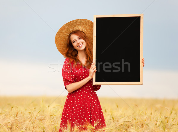 Redhead girl with blackboard at wheat field Stock photo © Massonforstock