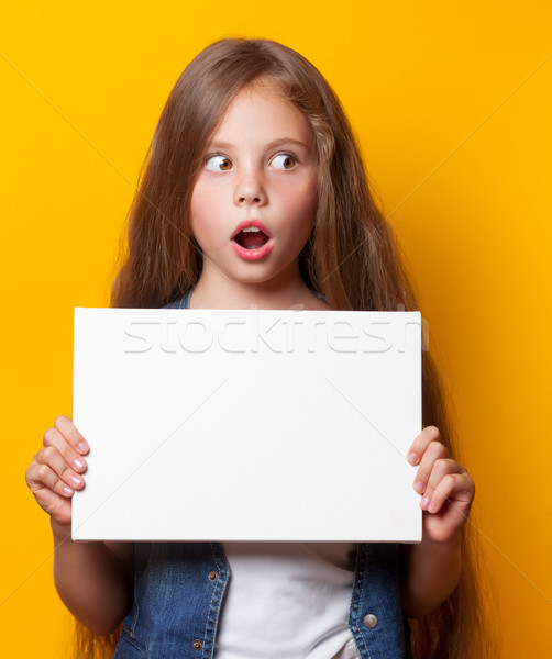 Beautiful young girl with white board Stock photo © Massonforstock