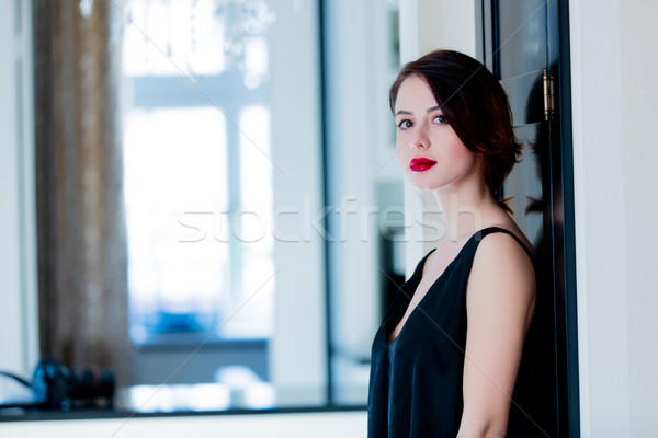 beautiful young woman standing near the door in the light luxury Stock photo © Massonforstock