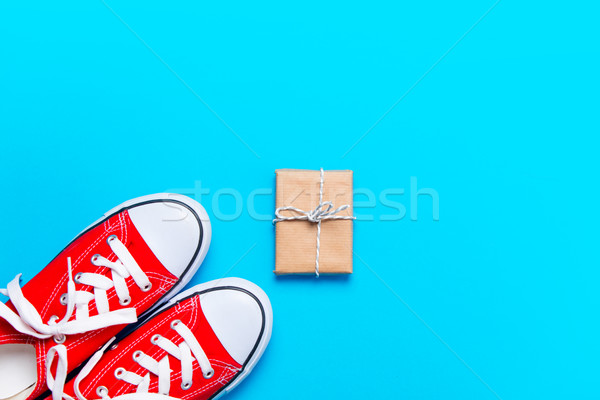 big red gumshoes and beautiful gift on the wonderful blue backgr Stock photo © Massonforstock
