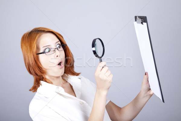 Young businesswomen with white plan board and loupe Stock photo © Massonforstock