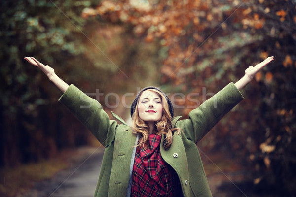 Style redhead girl at beautiful autumn alley. Stock photo © Massonforstock