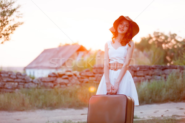 photo of beautiful young woman with suitcase on the wonderful vi Stock photo © Massonforstock