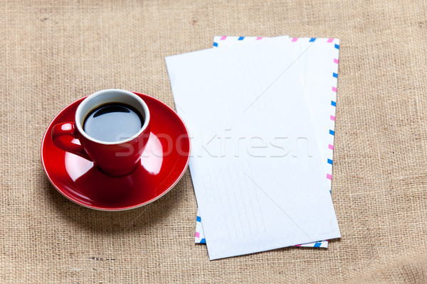 Stock photo: photo of red cup of coffee and several envelopes on the wonderfu