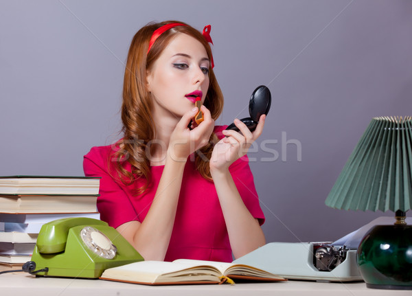 photo of beautiful young secretary correcting her make-up on the Stock photo © Massonforstock