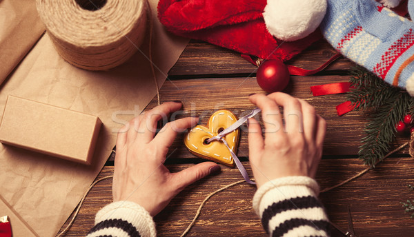 Woman wrapping a christmas cookie Stock photo © Massonforstock