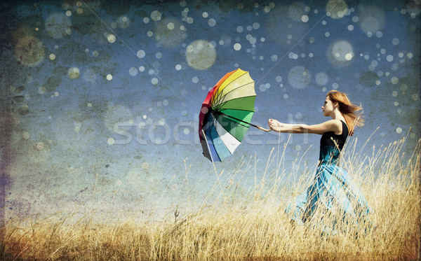 Ragazza ombrello ventoso erba prato Foto d'archivio © Massonforstock