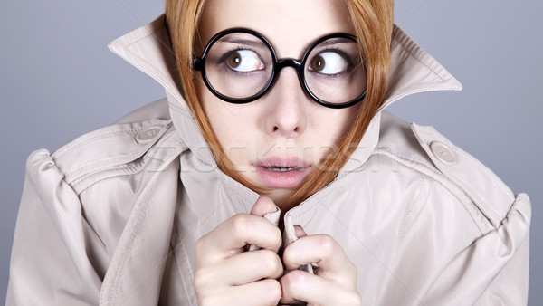 Ukrywanie dziewczyna okulary płaszcz zabawy Zdjęcia stock © Massonforstock